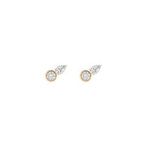 May include: A pair of gold stud earrings, each featuring a round brilliant-cut clear stone set in a bezel and a smaller pear-shaped clear stone attached to the side, creating a dual-stone design with a polished metallic finish and clear stones.