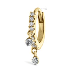 May include: A single gold hoop earring with a row of small, clear stones and two dangling, larger clear stones. The earring is a classic design, suitable for everyday wear.