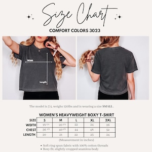 May include: A size chart for a Comfort Colors 3023 heavyweight boxy t-shirt. The image displays front and back views of a charcoal grey t-shirt with width and length indicators, a sizing table in inches, and product details including cotton fabric.