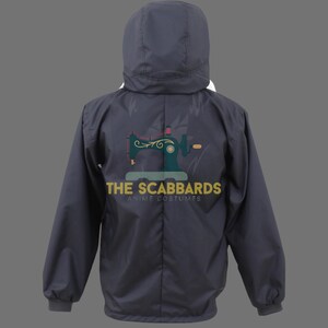 Op de afbeelding: Een donkergrijze jas met capuchon en een witte voering zichtbaar aan de rand van de capuchon. De achterkant van de jas heeft een turquoise naaimachine-afbeelding en de gouden tekst "THE SCABBARDS ANIME COSTUMES". De jas heeft lange mouwen.