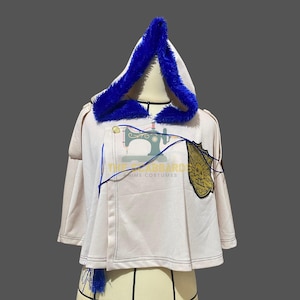 May include: A white cosplay cape with a blue fur-lined hood. The cape features a gold emblem and blue accents. The text "THE STARBARD ANIME COSTUMES" is visible on the cape.