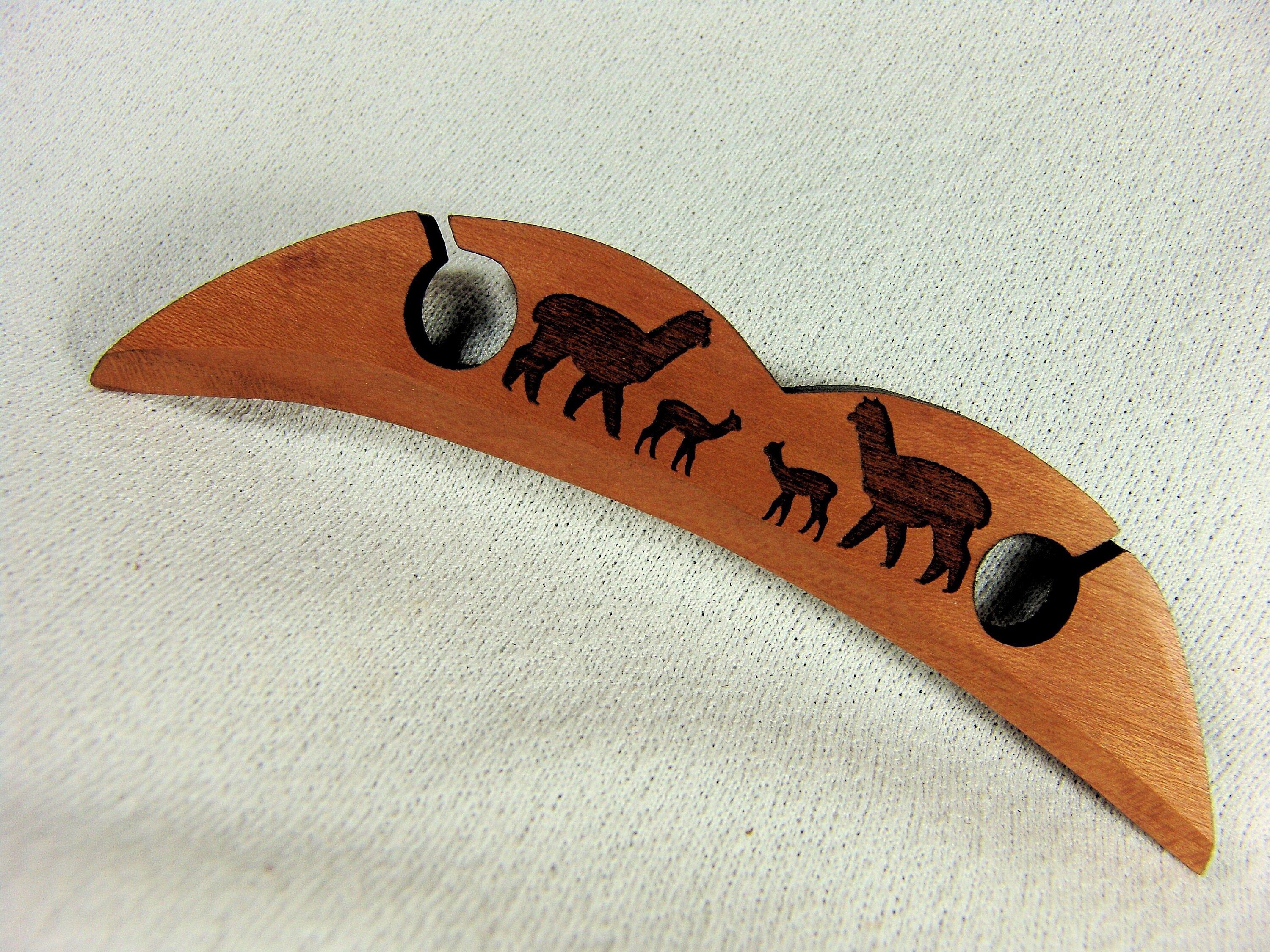 A Short Sword Form Shuttle for Traditional Scandinavian Tape Weaving with an Alpaca Family 5"