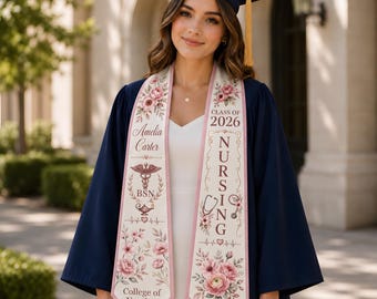 May include: A navy blue graduation gown and cap with a gold tassel, worn with a white dress and a custom graduation stole. The stole features pink floral designs, the text Amelia Carter, BSN, College of Nursing, Class of 2026, Nursing, and medical icons.