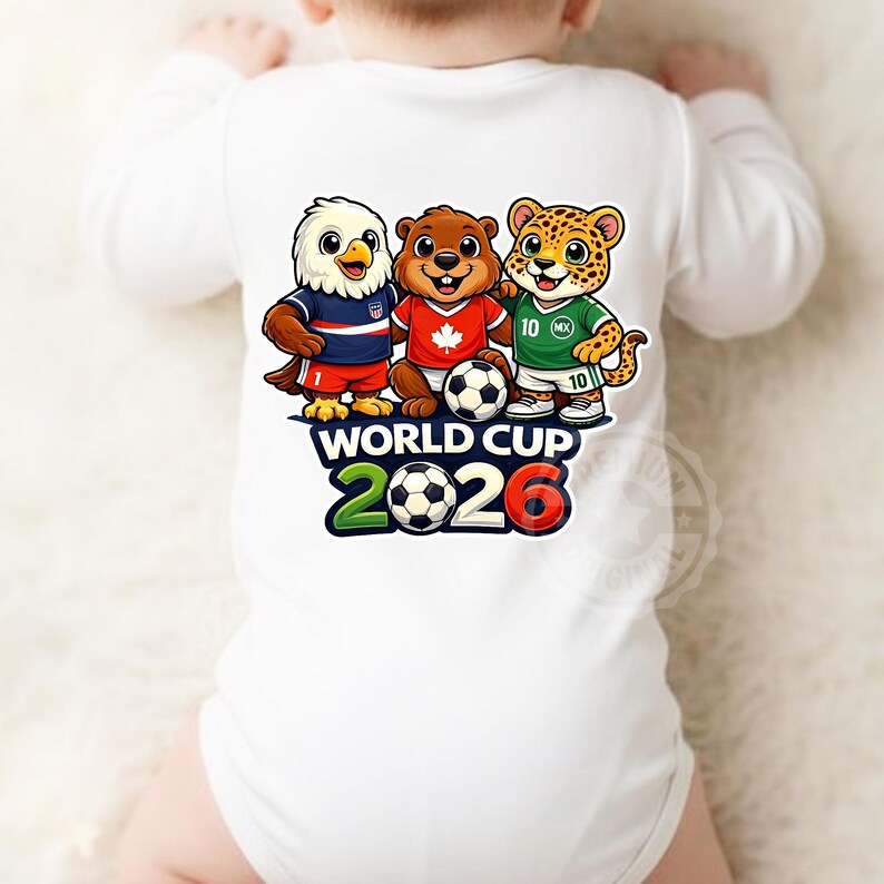 May include: White baby bodysuit with a cartoon design of an eagle, a beaver, and a jaguar, each with a football. The text "WORLD CUP 2026" is printed below the mascots in green, white, and red.