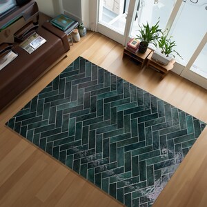 May include: A rectangular rug featuring a dark teal herringbone design. The rug is constructed from rectangular tiles with white grout lines. It rests on a light wooden floor. The room includes a brown leather sofa and a large window.