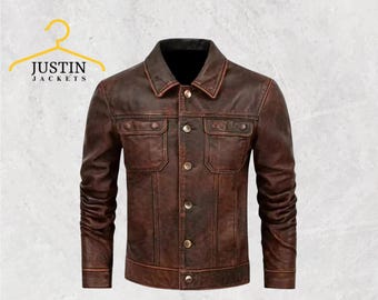 May include: A brown leather jacket with a button-up front, two chest pockets, and two side pockets. The jacket has a classic collar and the text "JUSTIN JACKETS" is visible on a yellow hanger.
