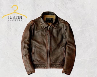 May include: A brown leather jacket with a zip-up front, two side pockets, and a collared neckline. The jacket has a distressed appearance and is labeled "JUSTIN JACKETS" in yellow on a hanger.