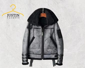 May include: A gray shearling jacket with a black shearling collar and lining. The jacket has a zipper closure, black accents, and buckle details on the sleeves. The brand name "JUSTIN JACKETS" is displayed on a yellow hanger.