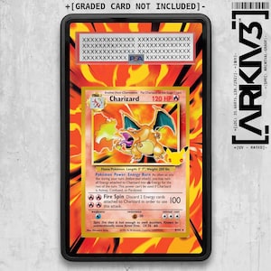May include: A black rectangular protective case containing a Charizard trading card with a fiery orange and yellow background. The card features the character Charizard, 120 HP, and text including Energy Burn and Fire Spin. The case has a PSA label.