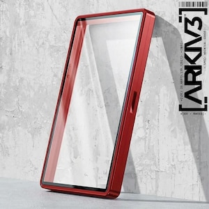 May include: A red rectangular phone case with a clear screen protector. The case has a sleek, modern design and is leaning against a textured gray wall. The text "ARKIV3" is visible on the right side of the case.