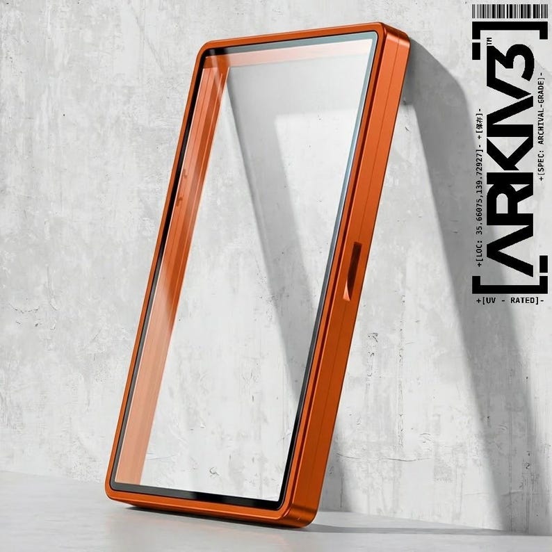 May include: An orange rectangular phone case with a clear screen protector. The case has a sleek, modern design with a black border around the screen. The text "ARKIV3" is printed vertically on the right side of the case.