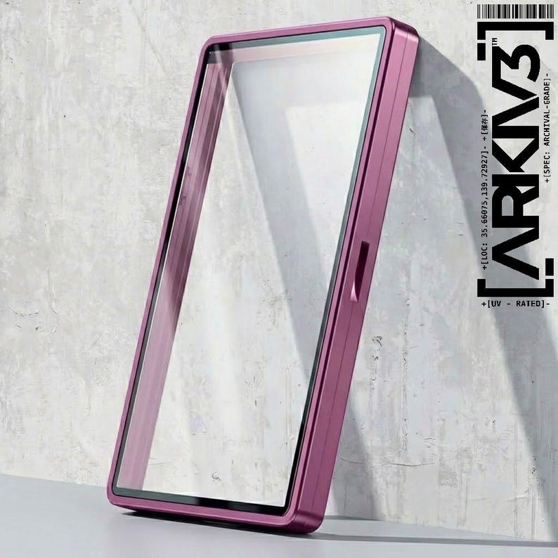 May include: A rectangular, magenta-colored phone case with a clear screen protector. The case has a slim profile and a metallic finish. The text "ARKIV3" and other technical details are printed on the right side.