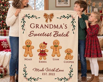 May include: A cream-colored fleece blanket featuring a brown gingerbread bow at the top, the text "GRANDMA'S Sweetest Batch", three gingerbread figures named Noah, Emma, and Liam, a puppy named Cooper, and the text "Made With Love EST. 2022".