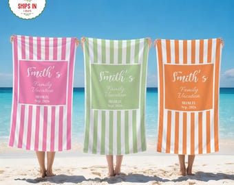 May include: Three personalized beach towels with vertical stripes in pink, green, and orange. Each towel has a white rectangle with the text "Smith's Family Vacation, Miami FL, Sep. 2026". The towels are held up on a sandy beach with a blue sky and ocean in the background.