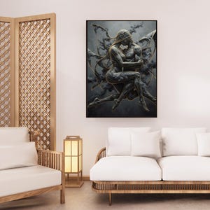 May include: A framed artwork depicts two figures embracing, rendered in shades of gray and gold against a dark, cloudy backdrop. The figures appear to be intertwined, with flowing golden accents. The artwork is displayed in a modern living space.