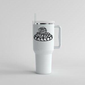May include: A white travel mug featuring a black illustration of a coiled snake. The mug has a handle, a lid, and a straw. The snake design is a bold, minimalist graphic, suitable for those interested in reptiles.