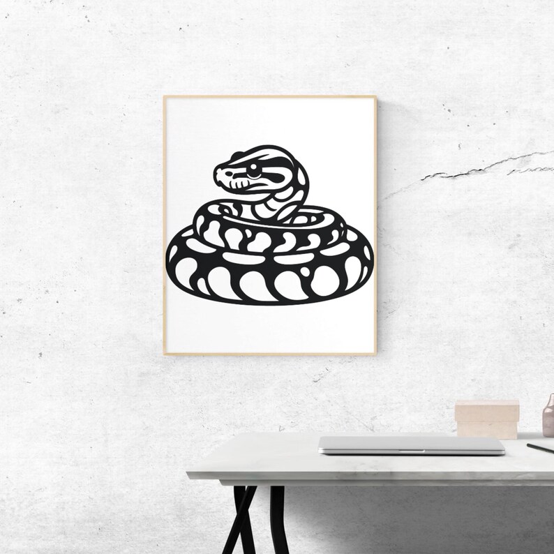 May include: A framed art print showing a coiled snake illustration in black and white. The snake has detailed patterns and a focused gaze, set against a white background. The artwork is displayed in a gold-coloured frame.