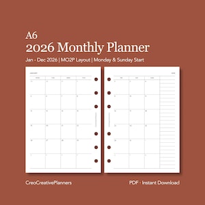 Può includere: Planner mensile A6 2026 con sfondo marrone. Il planner presenta un layout mensile con date di inizio lunedì e domenica. Il testo "Jan - Dec 2026" è visibile. Il planner è un download istantaneo PDF.