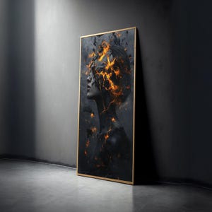 May include: A framed art print showing a side profile of a person with dark skin. The artwork has a fiery, cracked effect across the face and upper body, with gold accents. The frame is a thin, gold colour.
