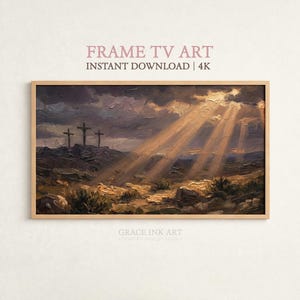 May include: A framed landscape painting depicts three crosses on a hill under a dramatic sky with sun rays. The artwork is in a wooden frame and features the text "FRAME TV ART INSTANT DOWNLOAD | 4K".