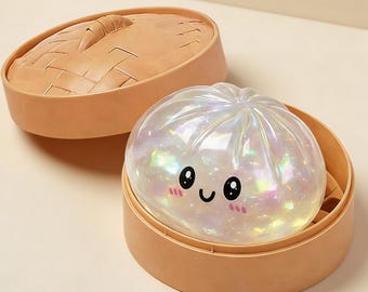 May include: A pearlescent, dumpling-shaped light with a smiling face, inside a tan bamboo steamer. The steamer lid is open, revealing the glowing dumpling. The light has a cute design and is a fun decorative item.