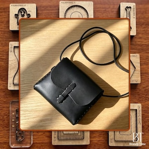 Könnte beinhalten: Eine schwarze Leder-Umhängetasche mit Klappenverschluss und langem, dünnem Riemen. Die Tasche ist rechteckig mit einem dekorativen Verschluss. Der Hintergrund umfasst Holzhandwerkzeuge und den Text "Brandy Time".