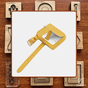 May include: A yellow luggage tag with a buckle closure and a strap. The tag has a clear window for an address card. The tag is surrounded by wooden craft stamps.