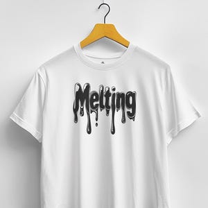 May include: White t-shirt with the word "Melting" in a black, dripping font. The design is centered on the chest. The shirt is hanging on a wooden hanger against a white background.