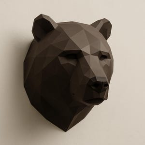 May include: A dark brown, geometric bear head sculpture mounted on a wall. The bear's head is constructed from multiple triangular and polygonal shapes, creating a low-poly design. The sculpture has a realistic bear face with closed eyes and a detailed nose.