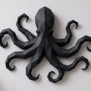 May include: A matte black wall sculpture of an octopus featuring a geometric, faceted design. The octopus has a central head and eight curved, segmented tentacles extending outward in a symmetrical arrangement, creating a low-poly aesthetic.