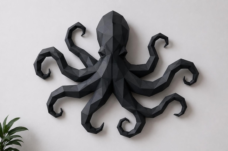 May include: A matte black wall sculpture of an octopus featuring a geometric, faceted design. The octopus has a central head and eight curved, segmented tentacles extending outward in a symmetrical arrangement, creating a low-poly aesthetic.