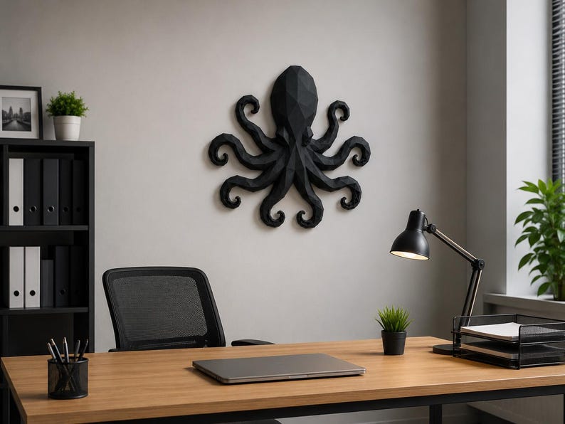 May include: A matte black wall-mounted octopus sculpture featuring a geometric, faceted design. The octopus has a central head and eight curved, segmented tentacles extending outward in a symmetrical arrangement, mounted on a plain wall.