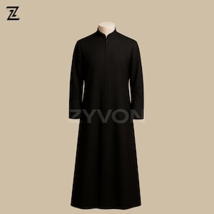 May include: A long, black coat with a mandarin collar and a full-length zipper. The coat is displayed on a mannequin. The text "ZYVON" is printed on the coat. The coat is a solid color and appears to be made of a heavy fabric.
