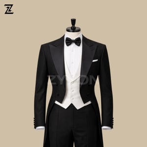 May include: A formal black tuxedo with a white vest, bow tie, and dress shirt. The tuxedo has a classic design with a long tailcoat and is displayed on a mannequin. The image includes the text "ZYOM".