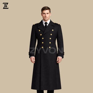 May include: A long, black double-breasted coat with gold buttons and shoulder details. The coat is tailored and worn over a white shirt and black tie. The brand name "ZYVON" is visible on the coat.