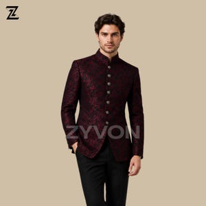 May include: A burgundy and black patterned jacket with a mandarin collar and silver buttons. The jacket is paired with black pants. The brand name "ZYVON" is visible on the jacket.