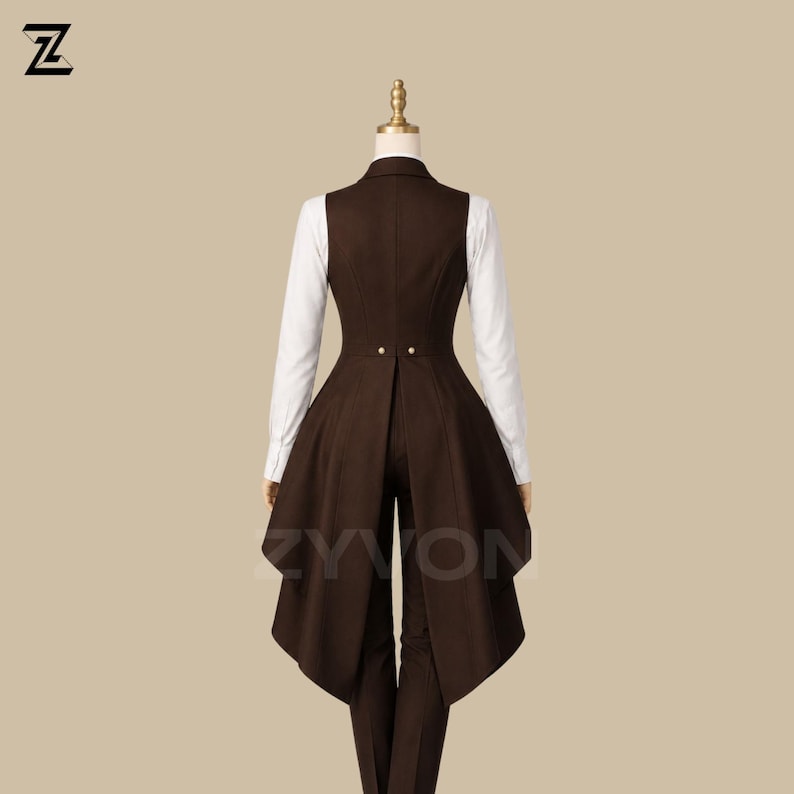 May include: A brown vest with a long, flared back, paired with matching pants and a white collared shirt. The vest features two gold buttons and a tailored fit. The outfit is displayed on a mannequin.