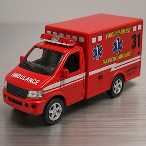 May include: A red toy ambulance with white stripes and the word "AMBULANCE" on the front. The side reads "FIRE DEPARTMENT" and "PARAMEDIC AMBULANCE" with a blue star of life symbol. The number 31 is visible. Emergency call 911.