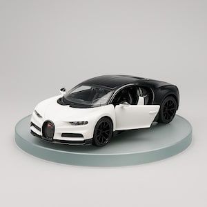 May include: A white and black model car with a door open, showcasing the interior. The car has black wheels and a black roof. The car is displayed on a round, clear platform.