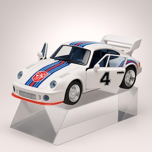May include: A white toy car with blue and red stripes and the number 4 on the door. The car has a spoiler and is displayed on a clear, angled stand. The car's design includes a logo on the hood.