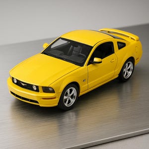 May include: A bright yellow model car with black interior. The car has a spoiler and silver rims. The car is a Mustang GT.
