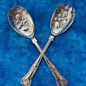 May include: A set of three ceramic nesting bowls in shades of blue, green, and white. The bowls feature a speckled glaze and a simple, modern design. The largest bowl is approximately 6 inches in diameter.