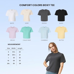 May include: A display of Comfort Colors Boxy Tees in various colors: white, ivory, pepper, black, orchid, chalky mint, chambray, and butter. Measurements are provided for sizes S to 2XL, with widths ranging from 18 1/8 to 26 inches and lengths from 20 to 24 inches.