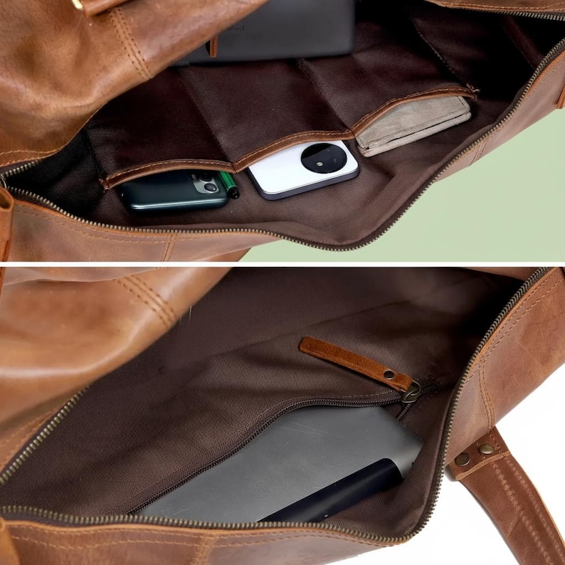 May include: A brown leather duffel bag with a dark brown fabric interior. The interior features multiple open slip pockets containing a white smartphone and a dark phone, plus a zippered compartment containing a flat electronic device.