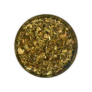 May include: Overhead view of a round, stainless steel container filled with dried, chopped green bell peppers. The peppers have a mix of light and dark green hues, with some tan pieces mixed in. The container sits against a white background.