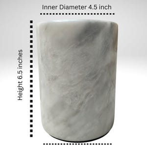 May include: A cylindrical, marble-like container with a height of 6.5 inches, an inner diameter of 4.5 inches, and an outer diameter of 5 inches. The surface has a swirling, gray and white pattern. The word "Dimensions" is at the top.
