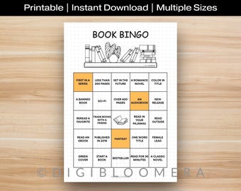 May include: A printable Book Bingo game with a grid of reading challenges. The black and white design features a bookshelf illustration at the top and various prompts like "Fantasy" and "Read in your pajamas". The text "Printable | Instant Download | Multiple Sizes" is at the top.