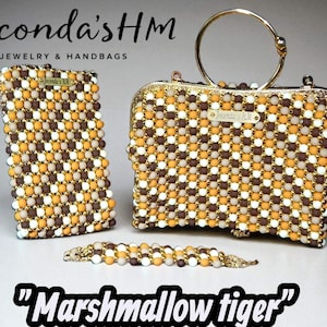 May include: A set of beaded accessories, including a clutch, handbag, and bracelet. The items feature a checkerboard pattern of brown, white, and yellow beads. The handbag has a gold handle. The text "Marshmallow tiger" is displayed.