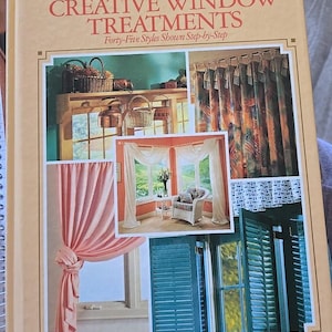 May include: A book cover for "CREATIVE WINDOW TREATMENTS" with the text "Arts & Crafts for Home Decorating." The cover displays images of different window treatments, such as curtains, drapes, and shutters. The book is from The Home Decorating Institute.