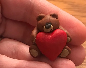 Teddy bear holding a red heart polymer clay